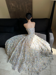 Sheer white base with appliqué, strapless, waist‑cinched, slim‑fit, long ball gown with a voluminous ruffled skirt R8015