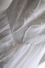 White fitted long ball gown with beaded details exudes elegance R6690