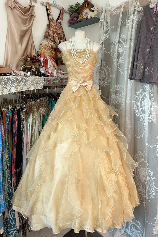 A gold, backless, fitted long dress with a multi-layered, voluminous skirt; a ball gown R6298